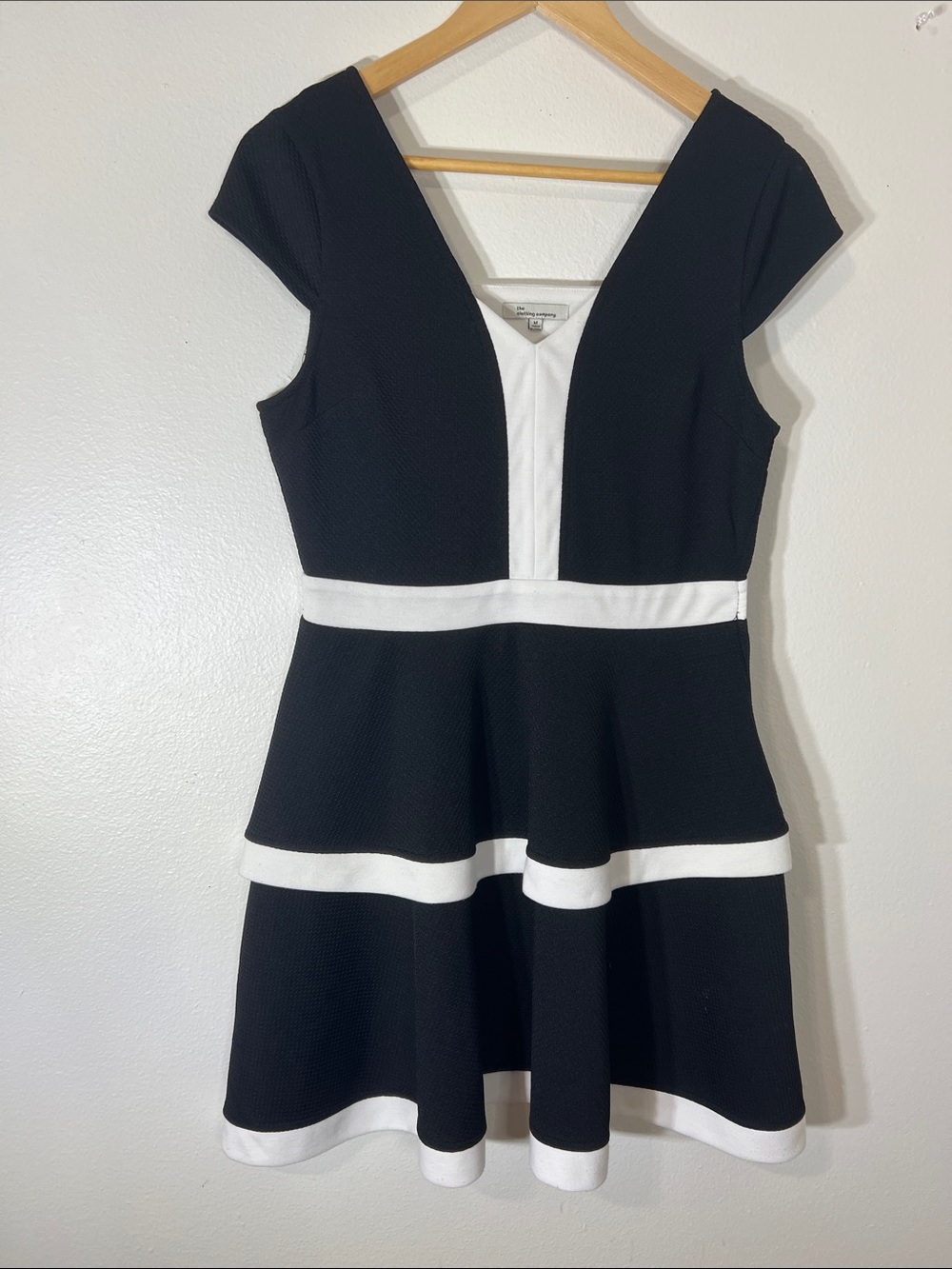 the clothing company Black & White V-Neck Peplum Mini Dress